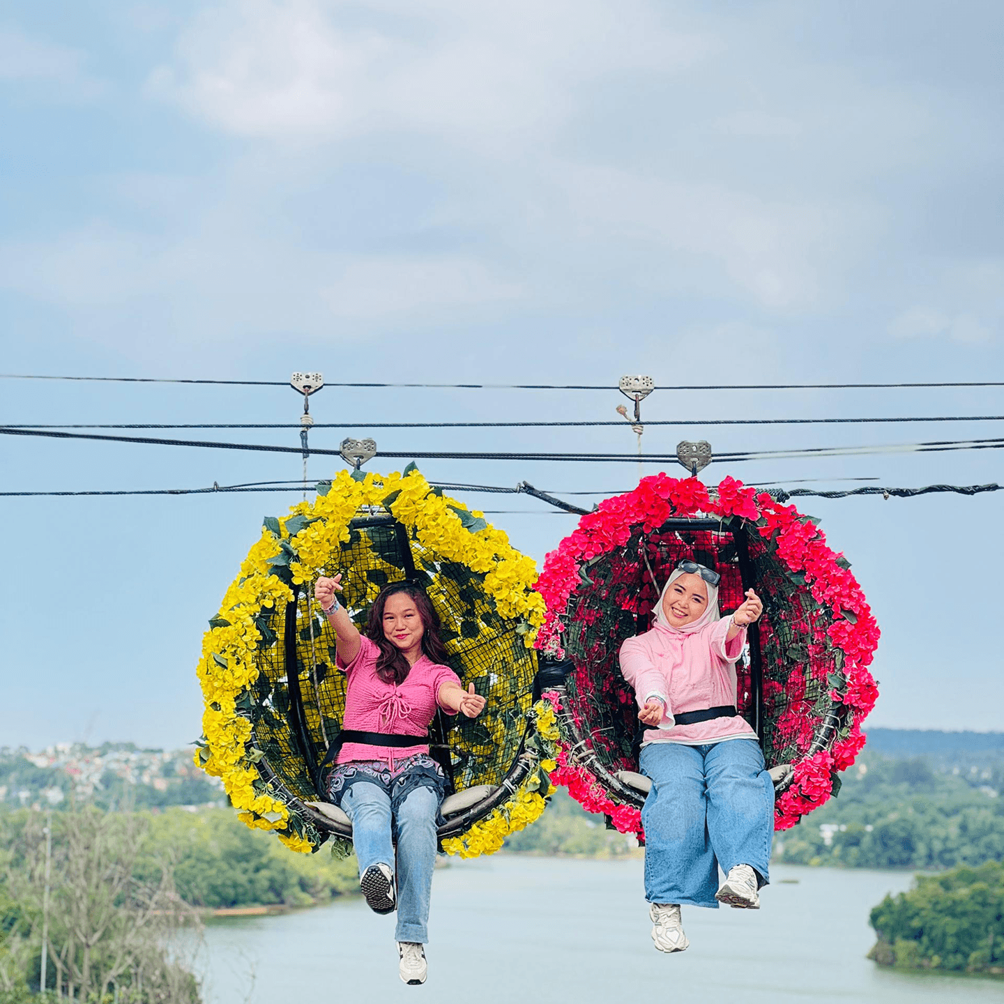 Travelers sitting on colorful swings above a scenic view